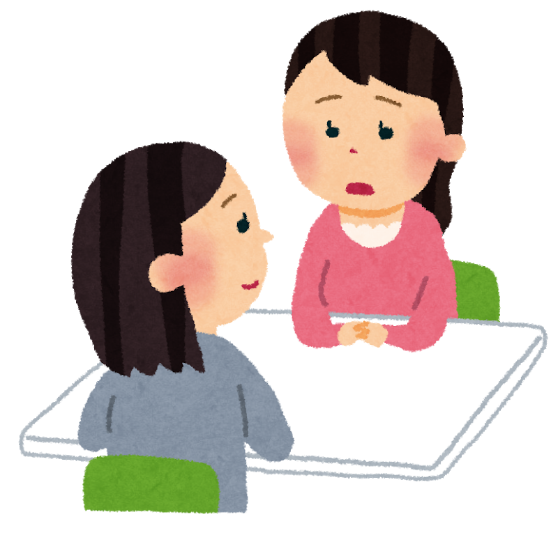 女性のカウンセラーと女性の相談者が机を挟んで相談しているイラスト
